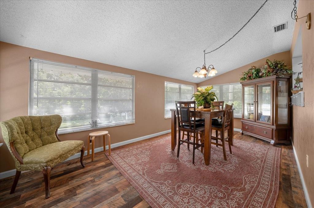 430 Southwest 43rd Place Ocala, FL 34471 - Photo 26 of 83 a dining room with furniture a rug and a large window
