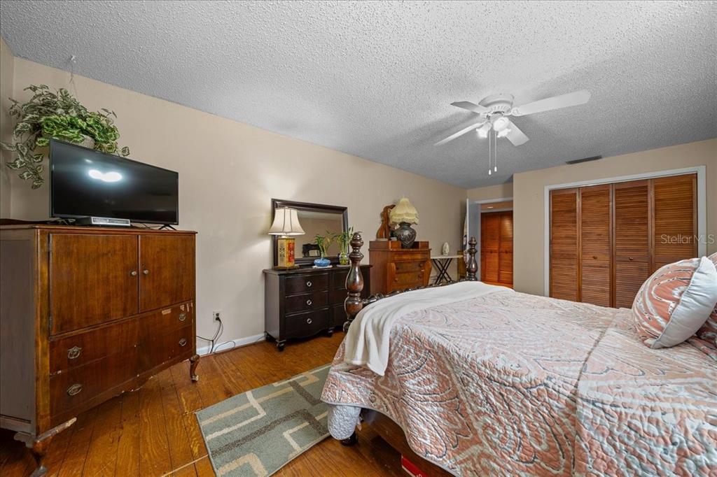 430 Southwest 43rd Place Ocala, FL 34471 - Photo 27 of 83 a bedroom with a bed and a large mirror