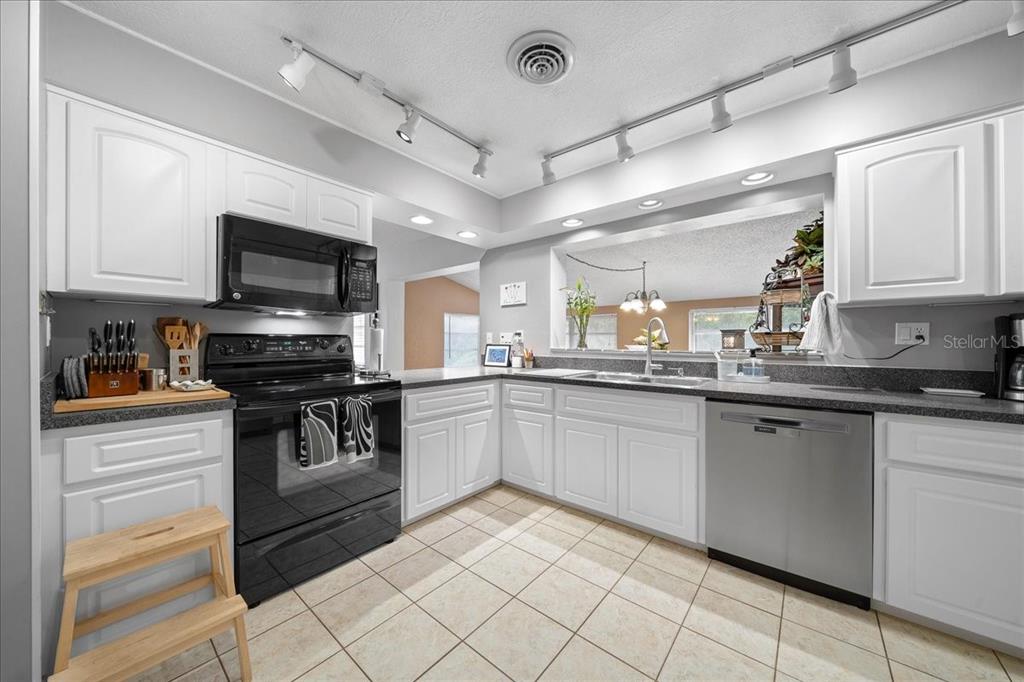 430 Southwest 43rd Place Ocala, FL 34471 - Photo 40 of 83 a kitchen with granite countertop a sink stainless steel appliances and cabinets