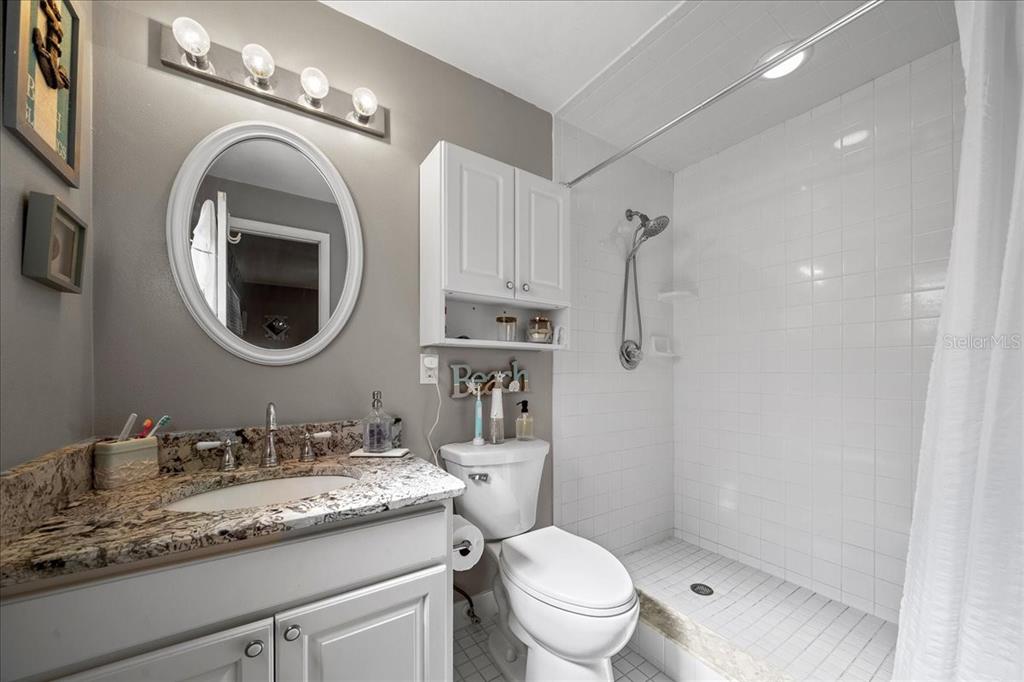 430 Southwest 43rd Place Ocala, FL 34471 - Photo 46 of 83 a bathroom with a granite countertop double vanity sink mirror and toilet