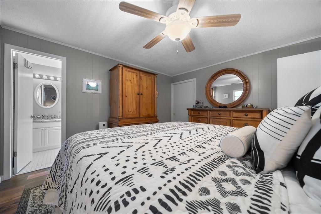 430 Southwest 43rd Place Ocala, FL 34471 - Photo 51 of 83 a bedroom with a large bed and a chandelier