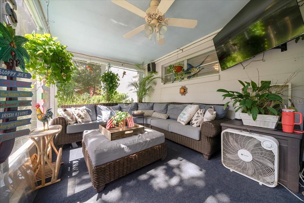 430 Southwest 43rd Place Ocala, FL 34471 - Photo 55 of 83 a living room with patio furniture and a flat screen tv