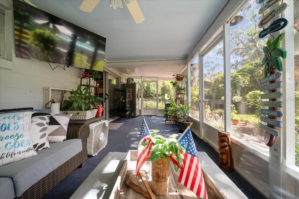 430 Southwest 43rd Place Ocala, FL 34471 - Photo 57 of 83 a living room filled with furniture and a floor to ceiling window