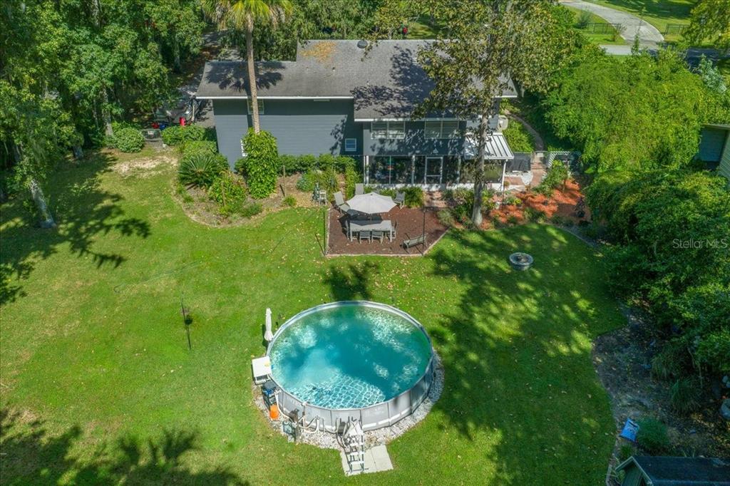 430 Southwest 43rd Place Ocala, FL 34471 - Photo 72 of 83 a backyard of a house with table and chairs and potted plants
