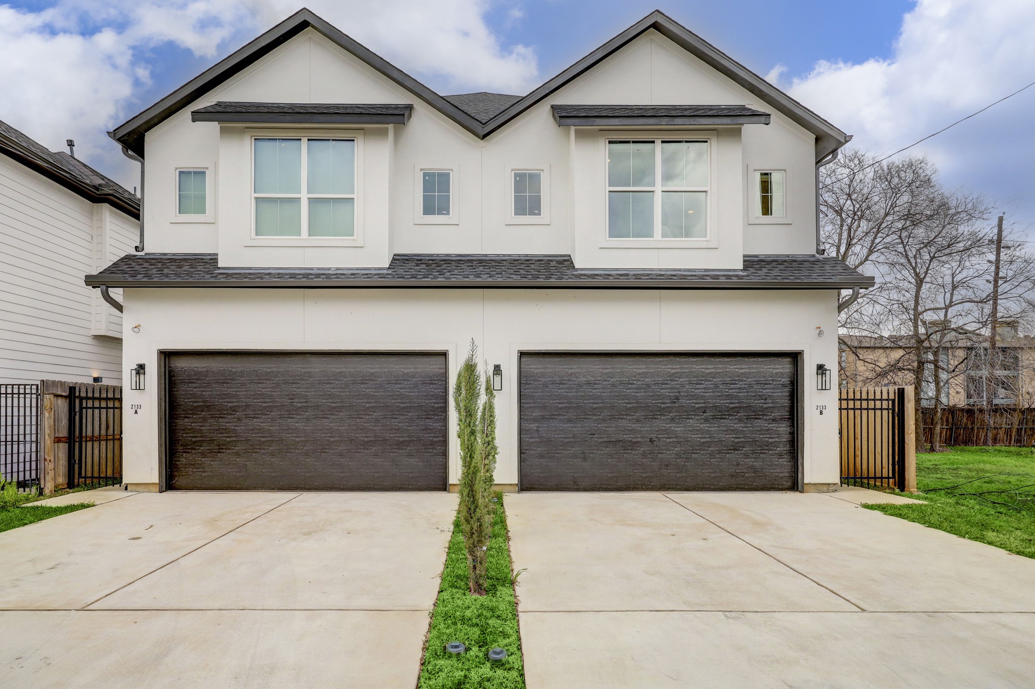 2133 Naomi Street, Unit A Houston, TX 77054 - Photo 1 of 11 a front view of a house with a yard and garage
