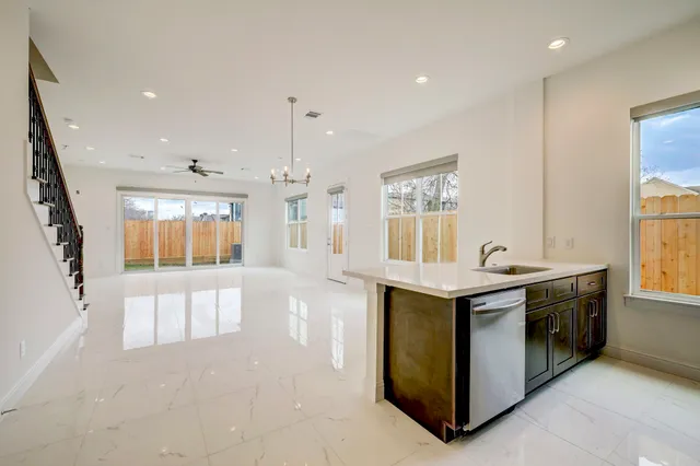 a large kitchen with stainless steel appliances granite countertop a stove and a sink