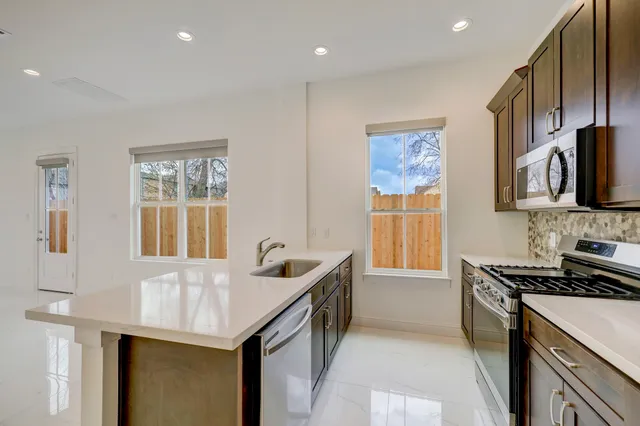 a kitchen that has a sink and a stove in it
