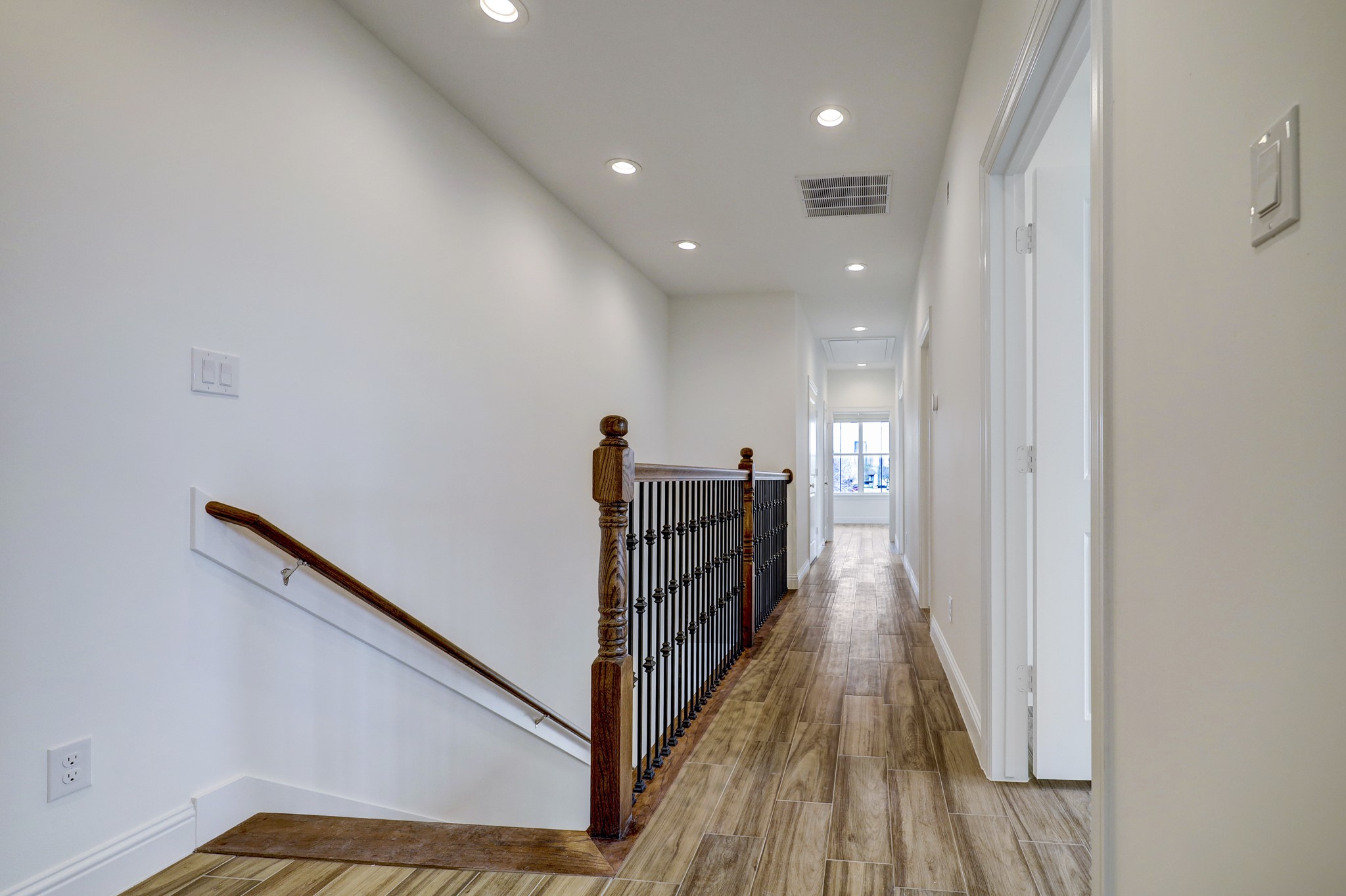 2133 Naomi Street, Unit A Houston, TX 77054 - Photo 5 of 11 a view of a hallway with wooden floor and staircase
