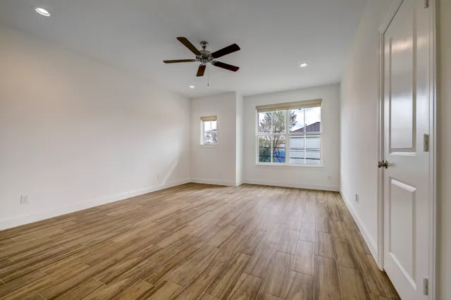 wooden floor in an empty room with a window