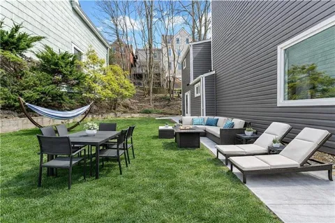 a view of a patio with table and chairs and potted plants