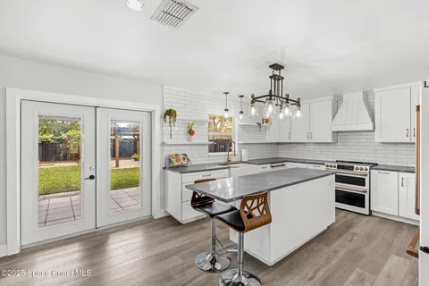 a kitchen with stainless steel appliances granite countertop a stove and a refrigerator