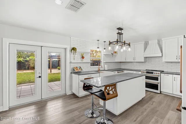 a kitchen with stainless steel appliances granite countertop a stove and a refrigerator