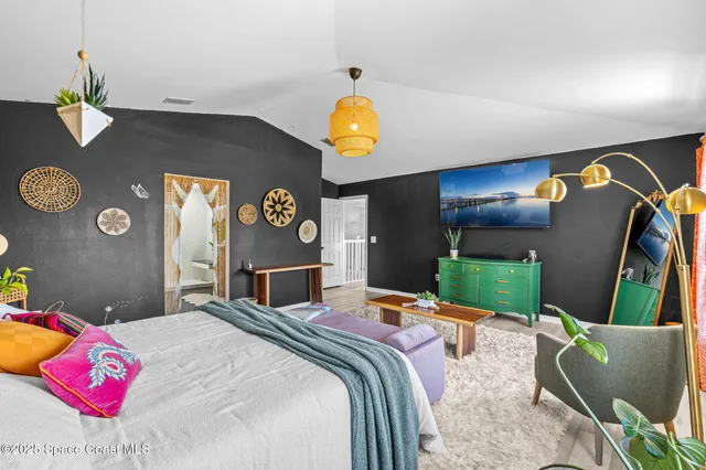 a bedroom with a bed and dresser