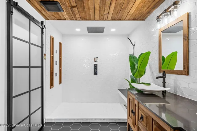 a bathroom with a tub sink and mirror