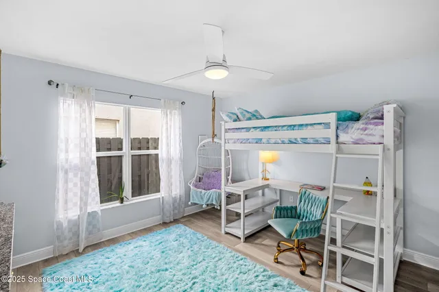 a bedroom with furniture and a window