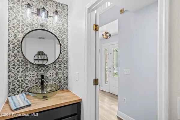 an aerial view of residential houses with outdoor space and lake view