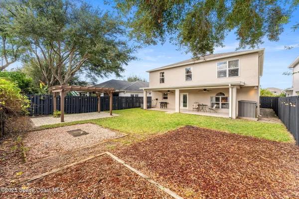 a view of a house with backyard and tree