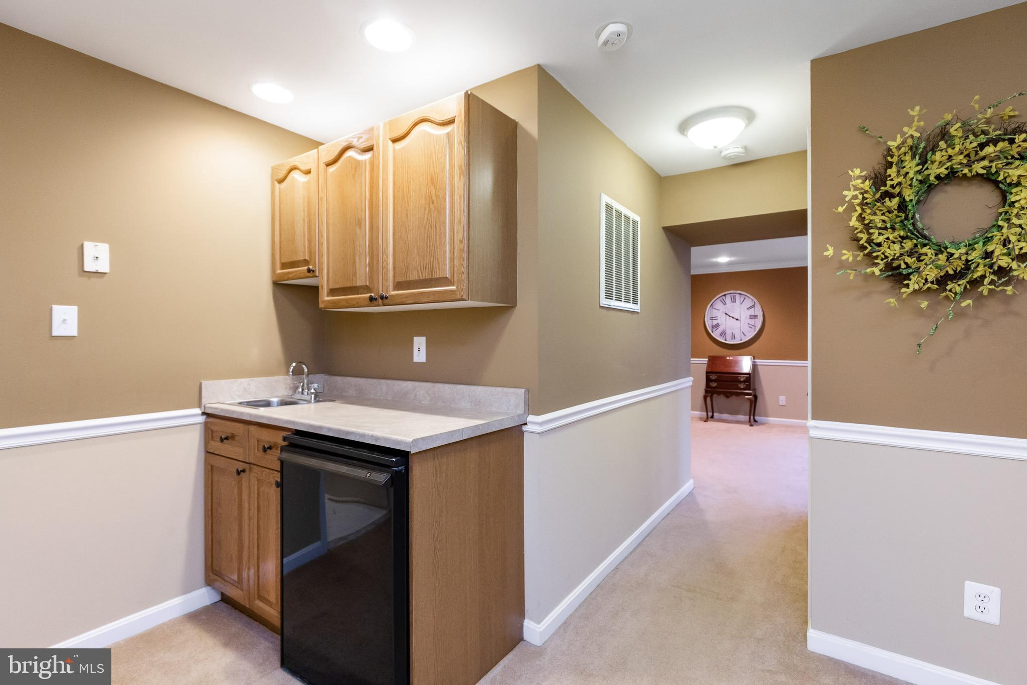 13080 Pershing Drive Manassas, VA 20112 - Photo 45 of 56 Basement wet bar and mini fridge