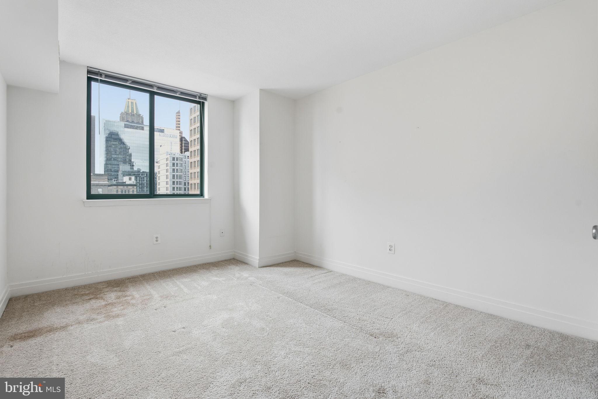 414 Water Street, Unit 1304 Baltimore, MD 21202 - Photo 12 of 24 an empty room with a window