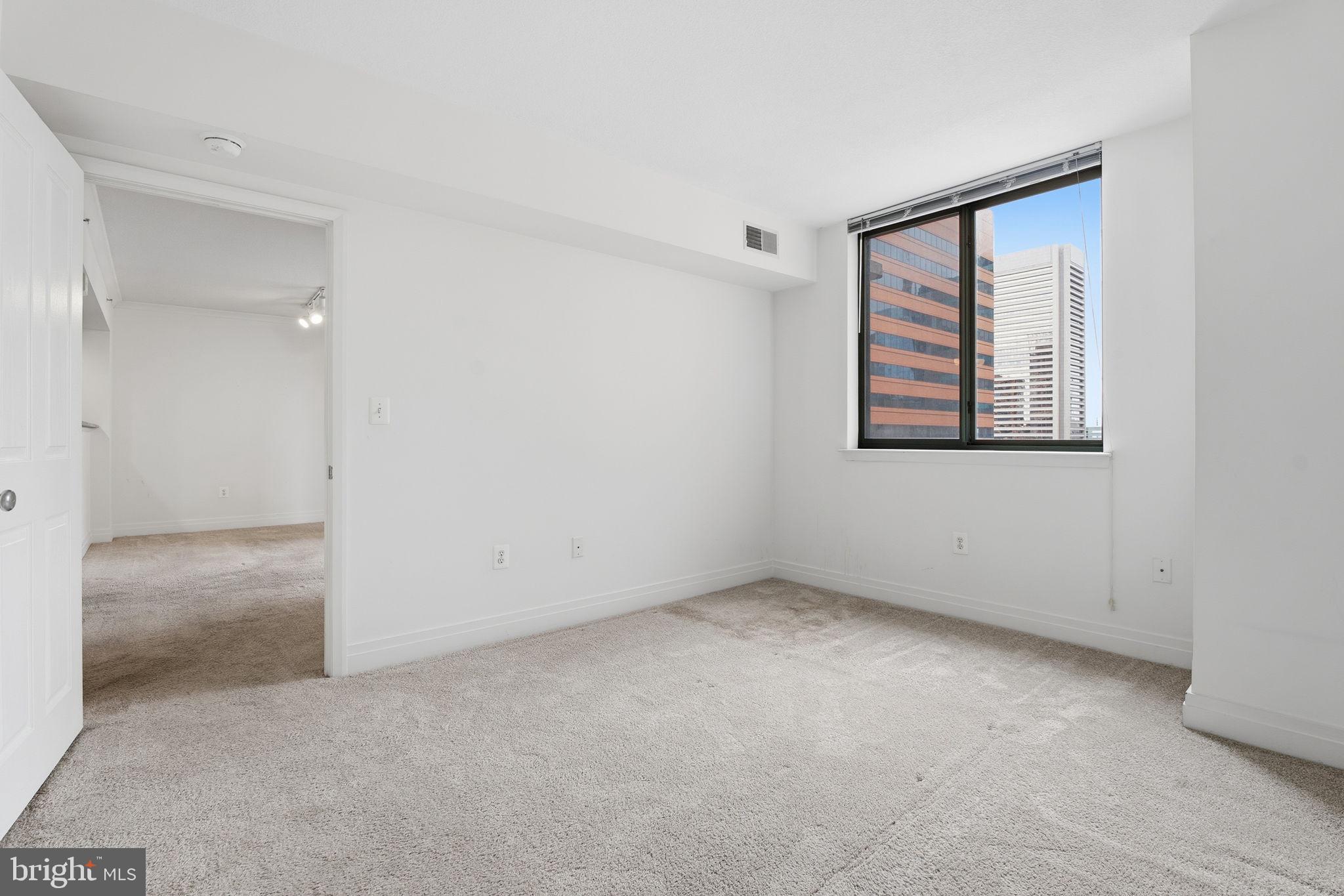 414 Water Street, Unit 1304 Baltimore, MD 21202 - Photo 13 of 24 an empty room with a window