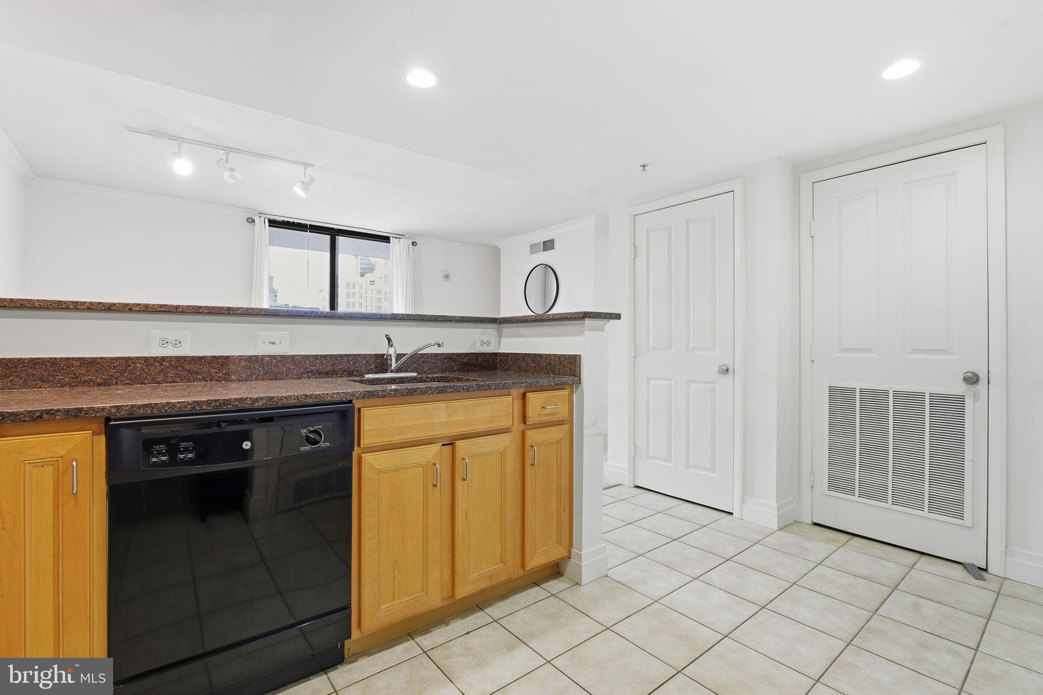 414 Water Street, Unit 1304 Baltimore, MD 21202 - Photo 9 of 24 a kitchen with stainless steel appliances granite countertop a stove and a sink