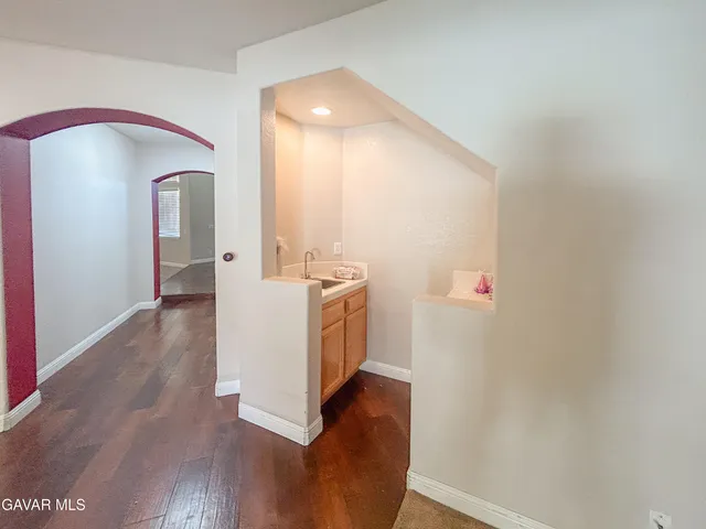 a view of living room with furniture and wooden floor