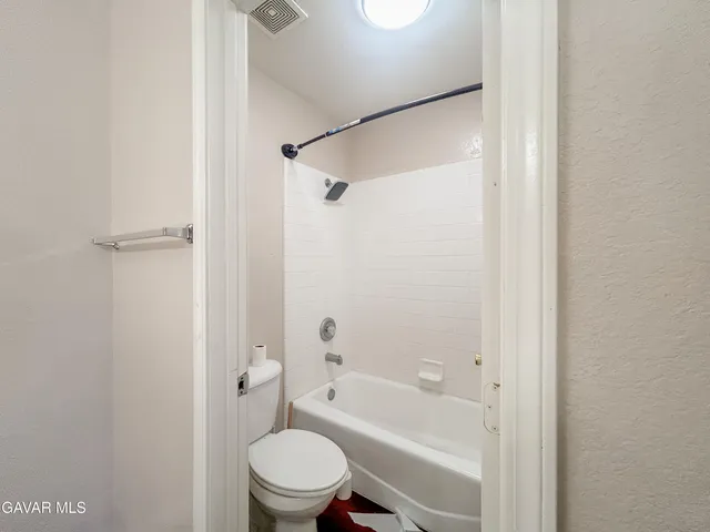 a bathroom with a toilet and a bathtub