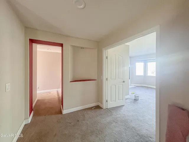 an empty room with a bathroom and a sink