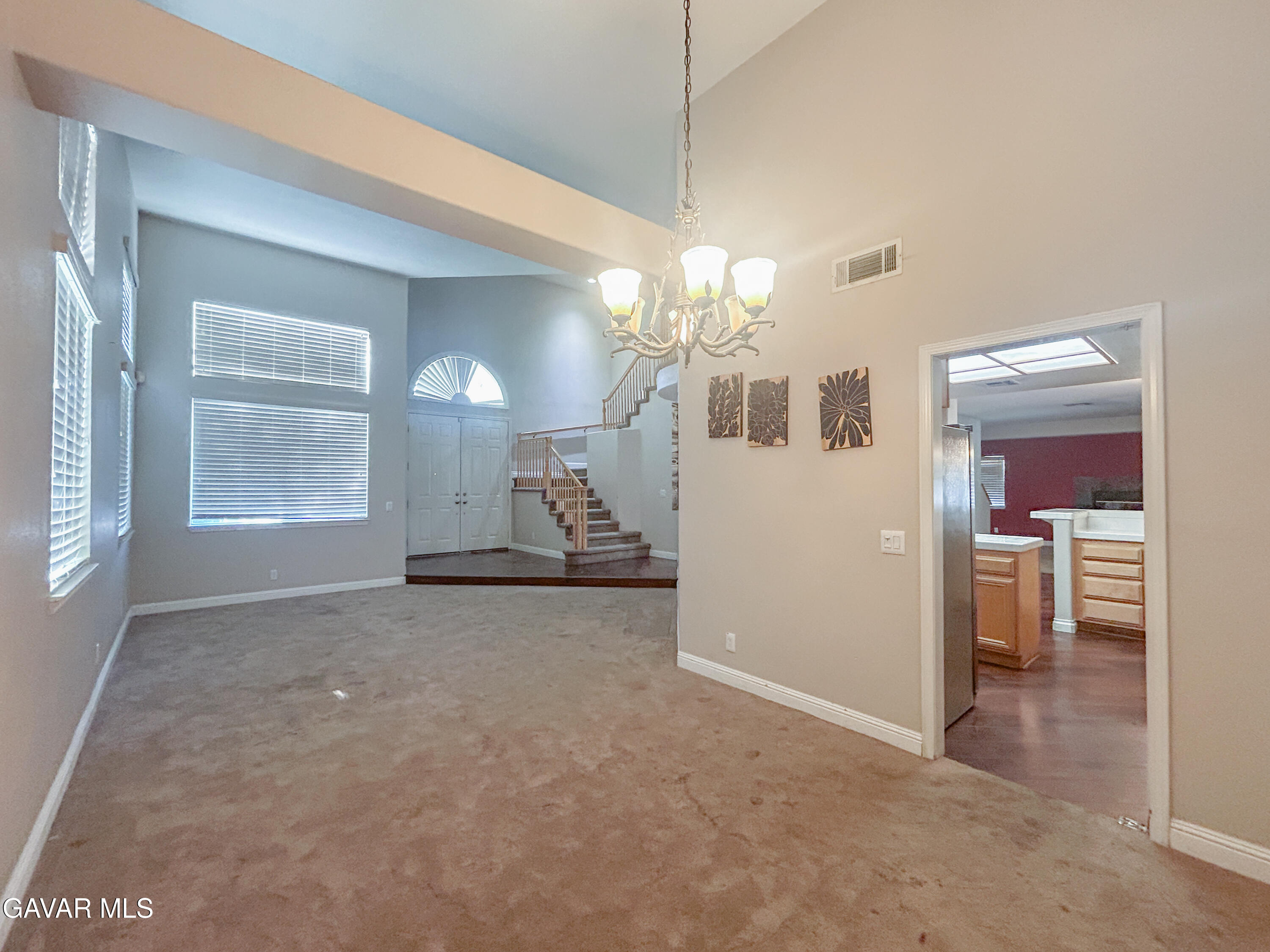 4011 Dee Dee Court Lancaster, CA 93536 - Photo 8 of 41 an empty room with chandelier and windows