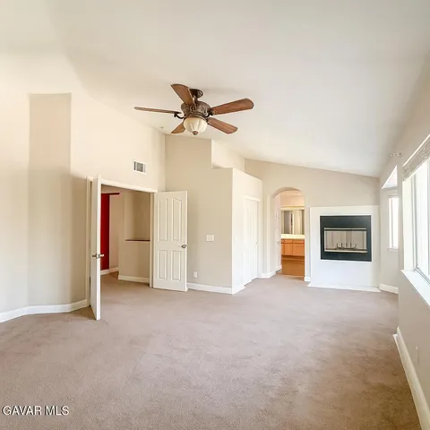 a view of a livingroom with an empty space and a ceiling fan