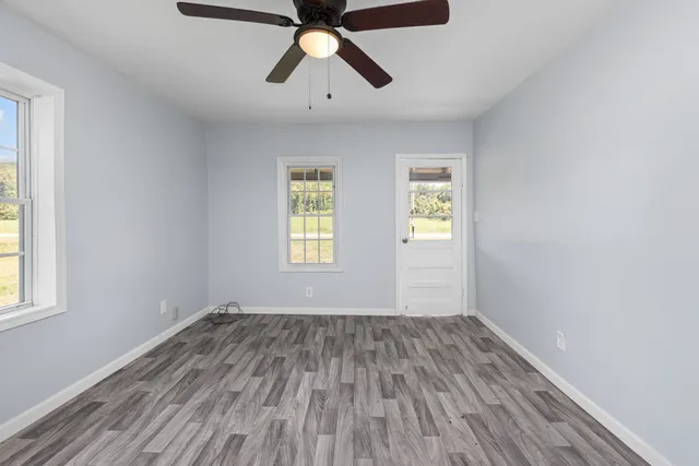 a view of empty room with wooden floor