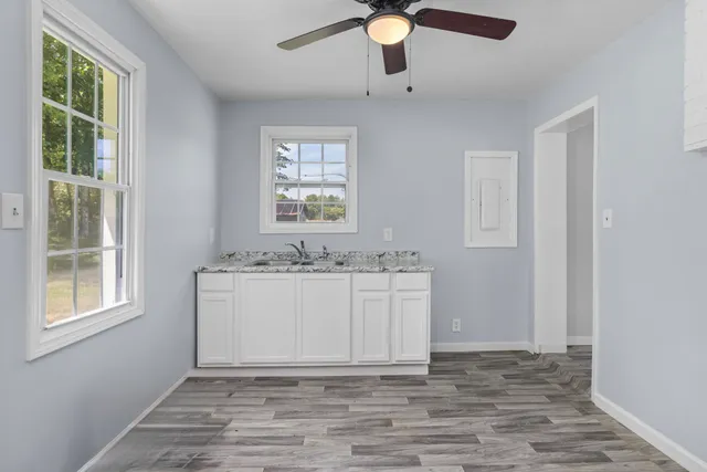 wooden floor in an empty room with a window