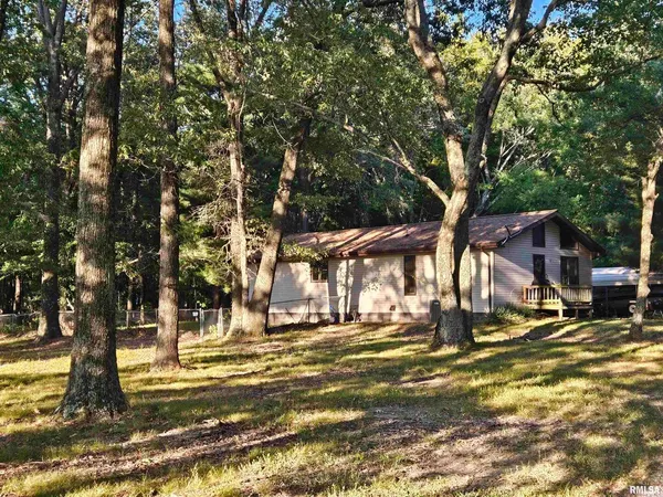 a view of a house with a tree in the background