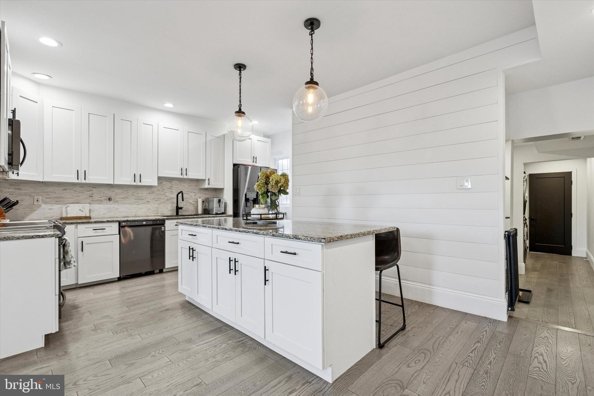 2694 Bridge Street Philadelphia, PA 19137 - Photo 7 of 41 a kitchen with kitchen island granite countertop a sink appliances cabinets and a counter top space