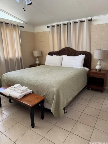 a bedroom with a bed and a dresser in it