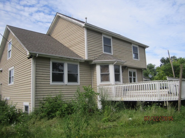 19105 McGuire Road Harvard, IL 60033 - Photo 3 of 16 a front view of a house with a garden
