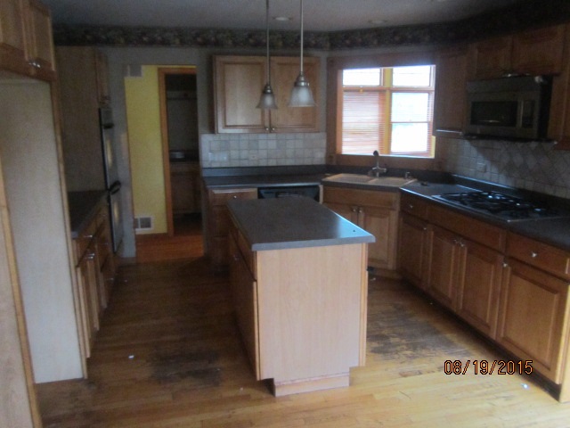 19105 McGuire Road Harvard, IL 60033 - Photo 9 of 16 a kitchen with a sink stove and refrigerator
