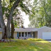 a front view of house with yard and green space