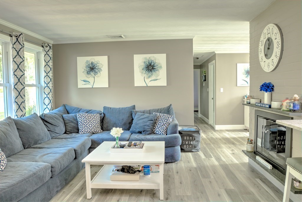 44 Ruthellen Road Chelmsford, MA 01824 - Photo 11 of 42 a living room with furniture a fireplace and a window