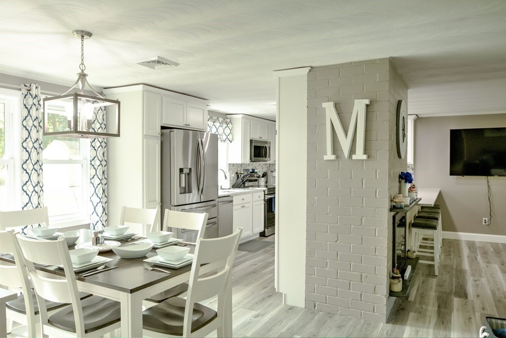 44 Ruthellen Road Chelmsford, MA 01824 - Photo 14 of 42 a kitchen with stainless steel appliances kitchen island granite countertop a refrigerator and a view of living room