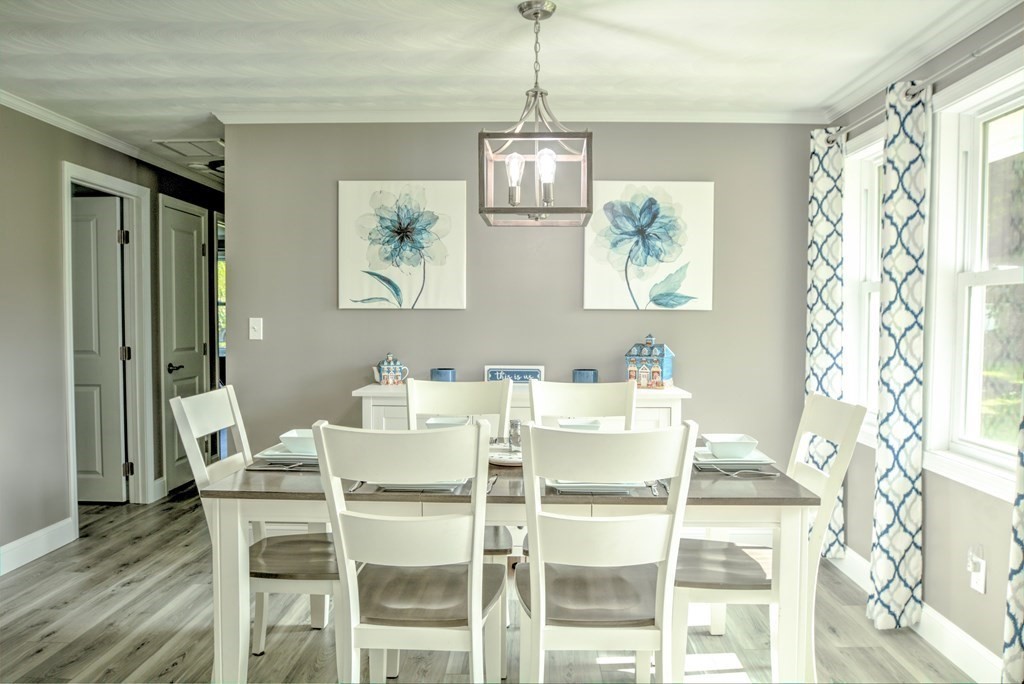 44 Ruthellen Road Chelmsford, MA 01824 - Photo 15 of 42 a dining room with wooden floor a chandelier a wooden table and chairs