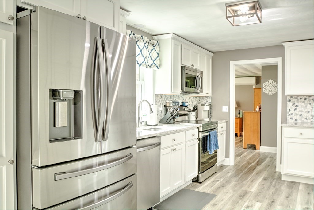 44 Ruthellen Road Chelmsford, MA 01824 - Photo 17 of 42 a kitchen with stainless steel appliances a refrigerator sink and cabinets