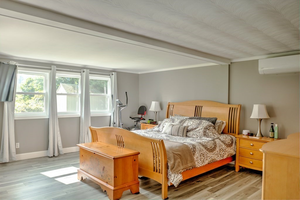 44 Ruthellen Road Chelmsford, MA 01824 - Photo 23 of 42 a bedroom with a bed and wooden floor