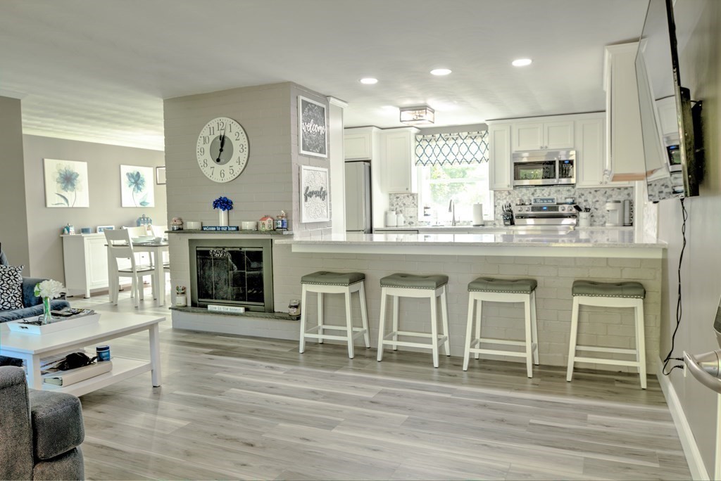 44 Ruthellen Road Chelmsford, MA 01824 - Photo 7 of 42 a open kitchen with granite countertop a stove oven and a fireplace