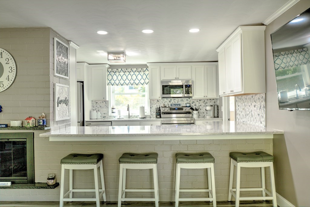 44 Ruthellen Road Chelmsford, MA 01824 - Photo 8 of 42 a kitchen with stainless steel appliances granite countertop a stove a sink and a refrigerator