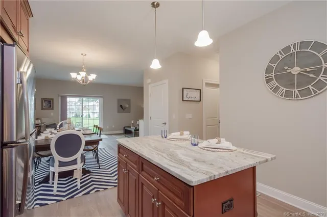 a bathroom with a granite countertop sink a mirror and a bathtub