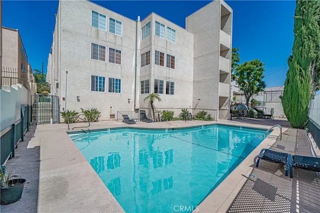 a swimming pool with outdoor seating and yard