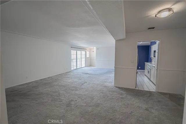 an empty room with entrance and windows