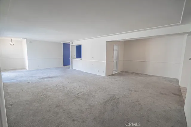 an empty room with a empty space and windows