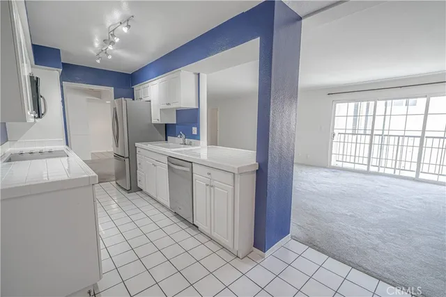 a view of a kitchen with storage and utility